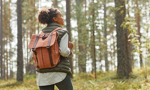 a person walking in the forrest with a backpack