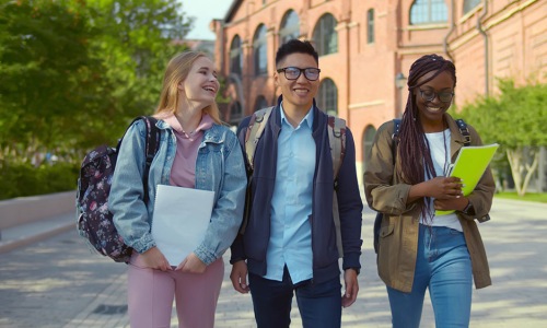 image showing 3 college students walking on campus